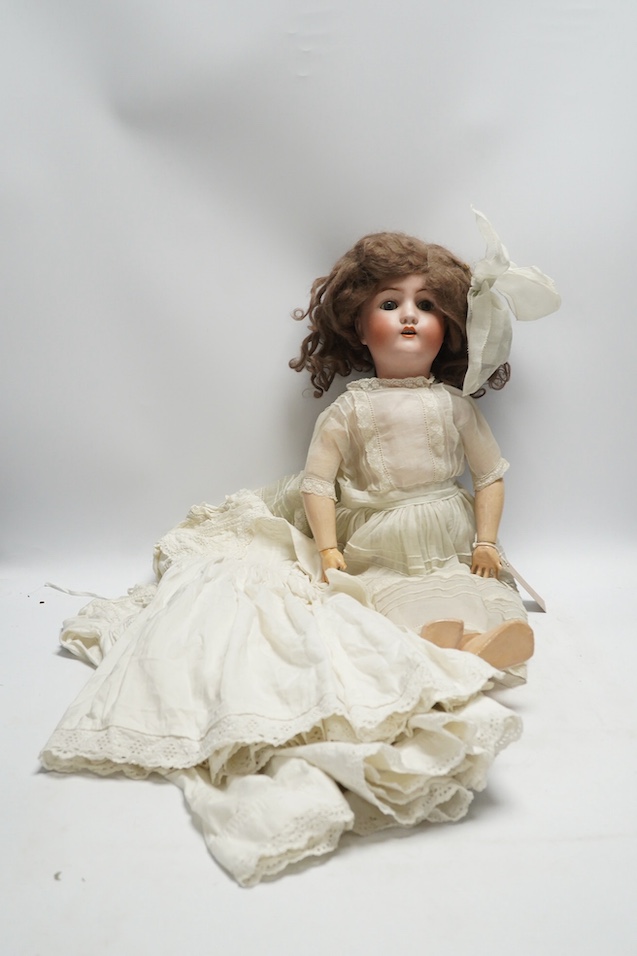 An Alt. Beck & Gottschalk bisque doll and three baby dresses, 61cm high. Condition - no visible hairline cracks to head or serious damage to body, dresses and dolls dress in good order, may need washing
